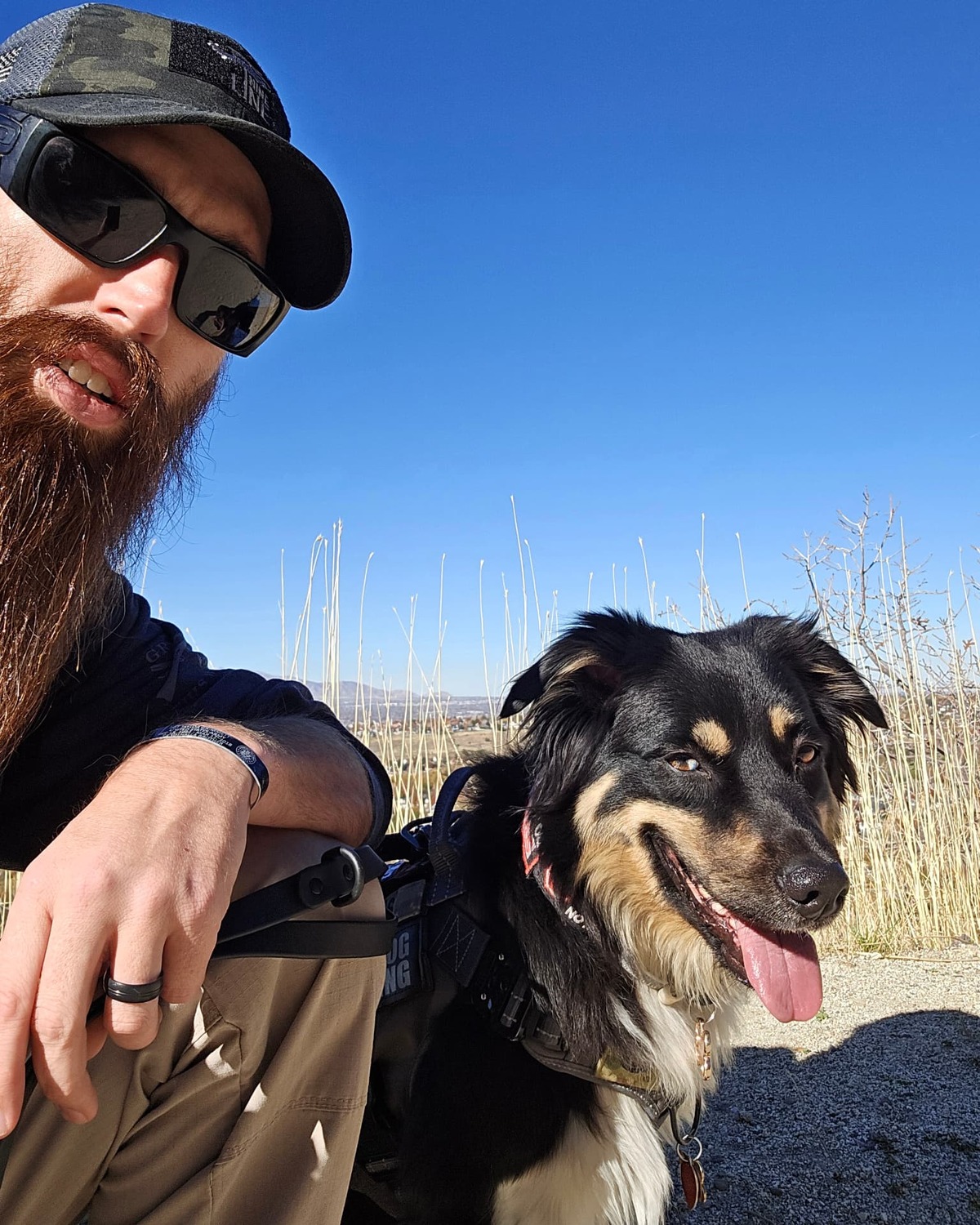 Brennan Hymas, founder of Patriot Pawz K9 Training, with his dog outdoors